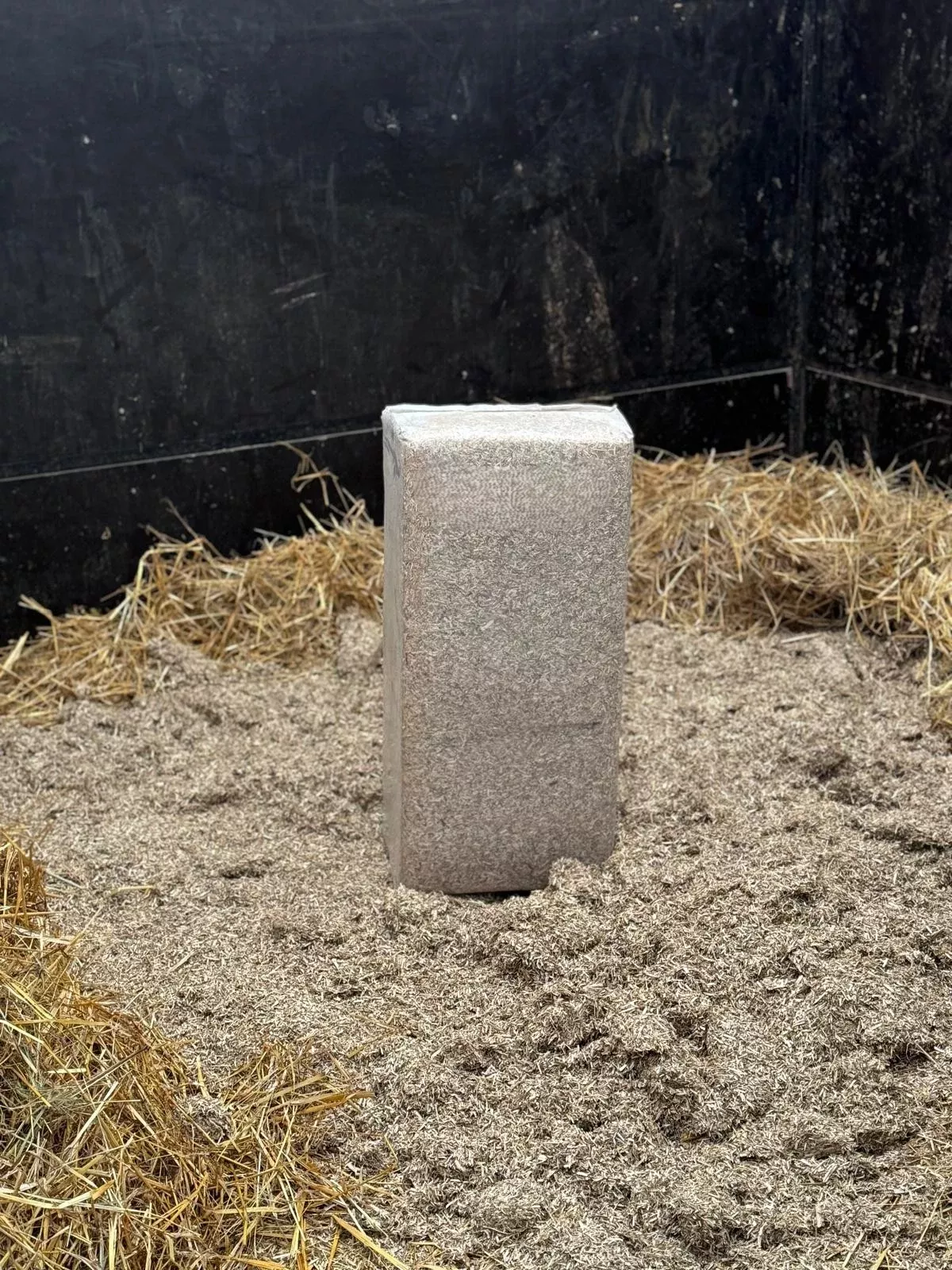 New LinoBed flax bedding bale placed in horse stall ready for refilling after cleaning